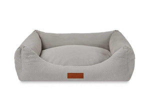 Orthopedic memory foam dog bed with beige knitted upholstery and orthopedic support