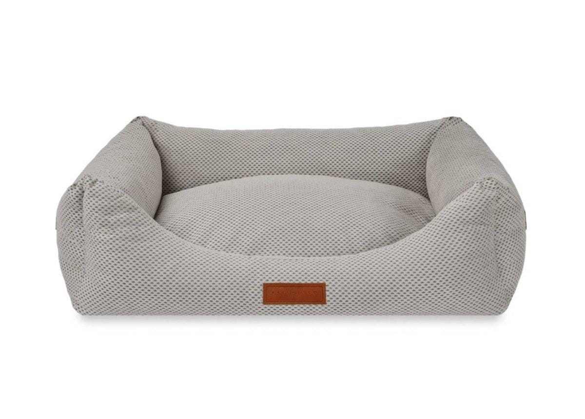Orthopedic memory foam dog bed with beige knitted upholstery and orthopedic support