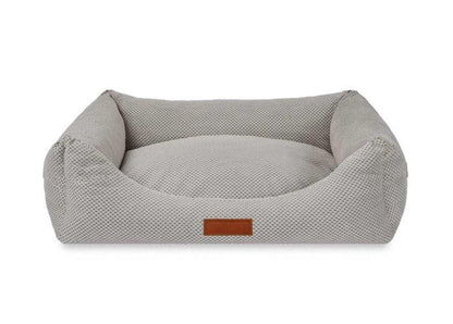 Orthopedic memory foam dog bed with beige knitted upholstery and orthopedic support