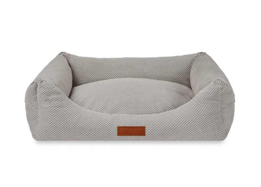 Orthopedic memory foam dog bed with beige knitted upholstery and orthopedic support