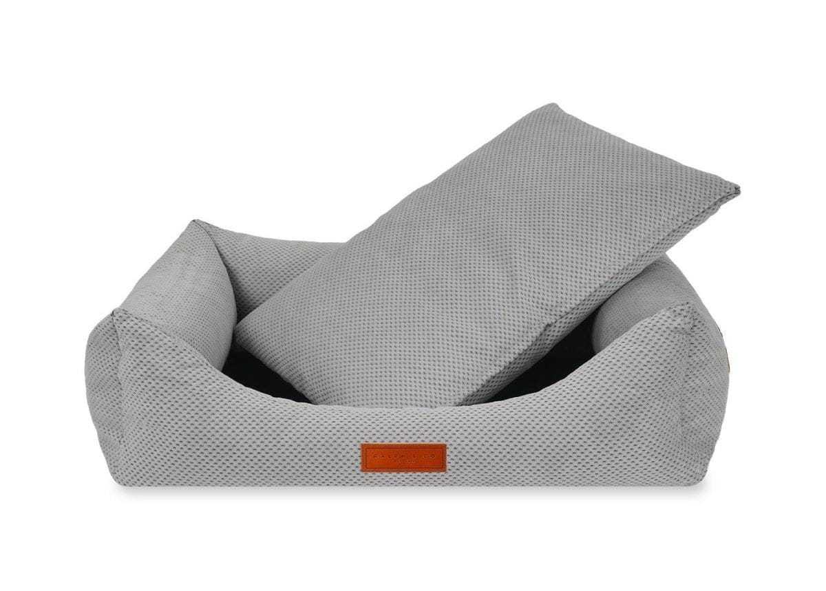 Orthopedic memory foam dog bed with beige knitted upholstery for joint support and comfort