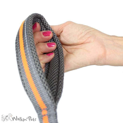 Walkin’ Wheelchair Dog Leash in fluorescent orange with reflective stitching attached to dog wheelchair